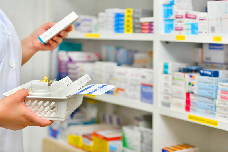 lady-at-pharmacy-checking-out-medications-in-a-basket